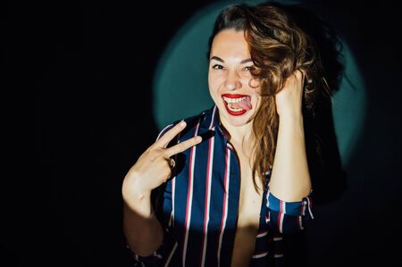 happy beautiful girl having fun in front of the camera on a green backgroundの写真素材