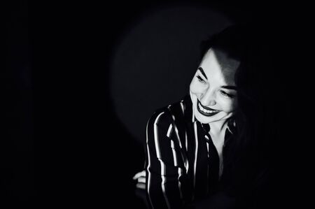 happy beautiful girl having fun in front of the camera on a green backgroundの写真素材
