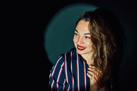 happy beautiful girl having fun in front of the camera on a green backgroundの写真素材