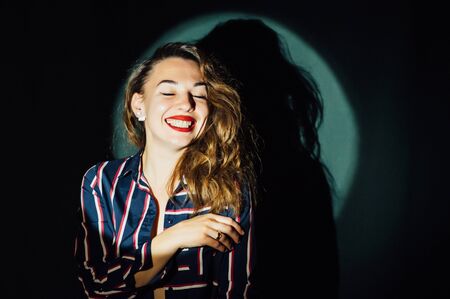 Close up portrait of young happy woman on green backgroundの写真素材