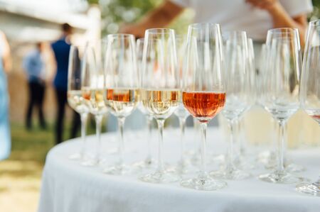 A row of empty champagne glasses on table. Banquet setting