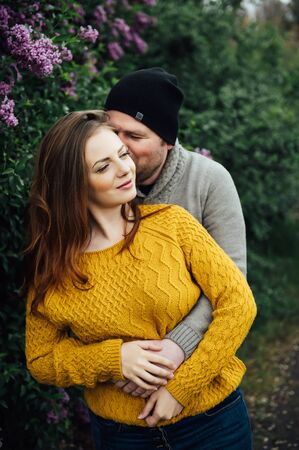 Beautiful couple in love is hugging near a lilac bush. lifestyle photoの写真素材
