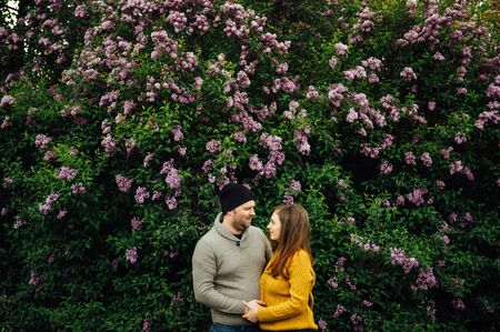 Beautiful couple in love is hugging near a lilac bush. lifestyle photoの写真素材