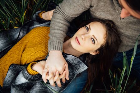 Gorgeous girl lies on her boyfriend lapの写真素材