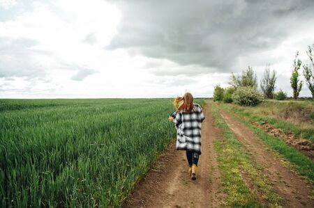 Beautiful brunette lady in wheat field at sunset.の写真素材