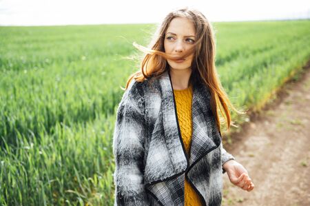 Beautiful brunette lady in wheat field at sunset.の写真素材