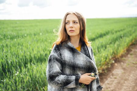 Beautiful brunette lady in wheat field at sunset.の写真素材