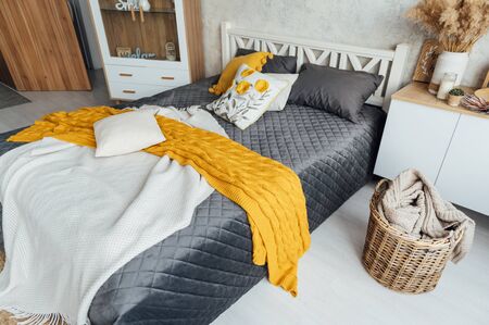 coziness, comfort, interior and holidays concept - cozy bedroom with bed..の写真素材
