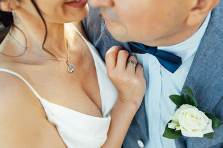 Close-up portrait of a bride and groom standing on the city street and lovely huggingの写真素材