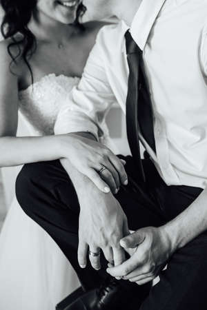close-up portrait of the bride and groom. They hug their arms. Wedding rings on their handsの写真素材