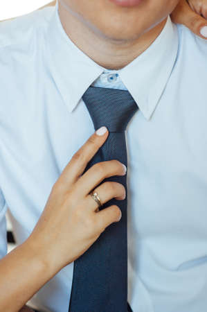 Man groom in wedding suit with bow tie. Hands bride, care, fix, adjust, fashionの写真素材