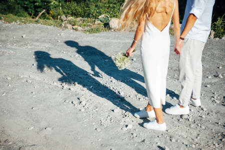 Happy young couple walking together in a green park