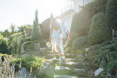 Happy young couple walking together in a green parkの写真素材
