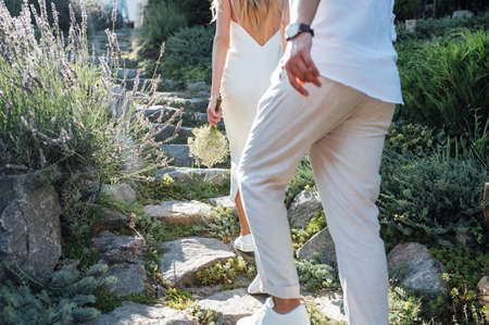 Happy young couple walking together in a green park