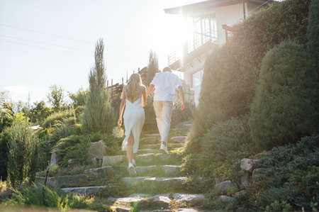 Happy young couple walking together in a green parkの写真素材