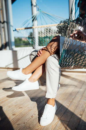 Couple in love has fun on a mesh hammock, in the sunの写真素材