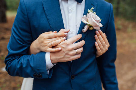 Elegant wedding couple. Bride and groom embracing at wedding dayの写真素材