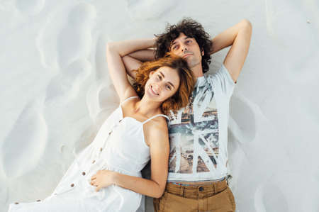 Couple walking on beach. Young happy interracial couple walking on beachの写真素材