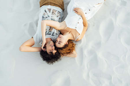 Couple walking on beach. Young happy interracial couple walking on beachの写真素材