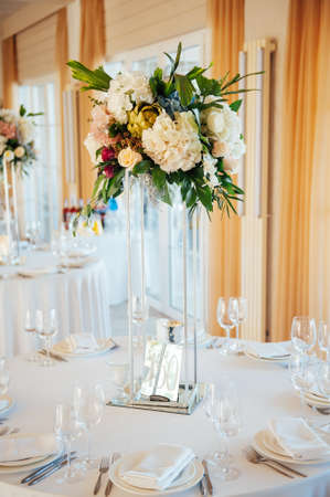 A beautiful vase of flowers on a table in a luxury restaurant. Wedding decorationsの写真素材