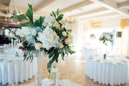 A beautiful vase of flowers on a table in a luxury restaurant. Wedding decorationsの写真素材
