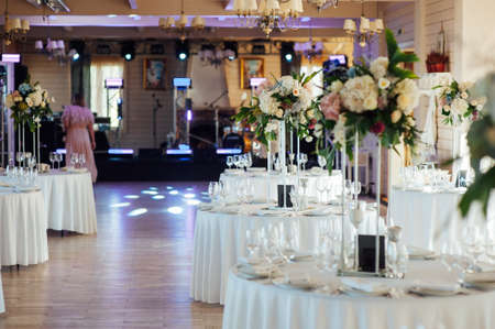 A beautiful vase of flowers on a table in a luxury restaurant. Wedding decorationsの写真素材