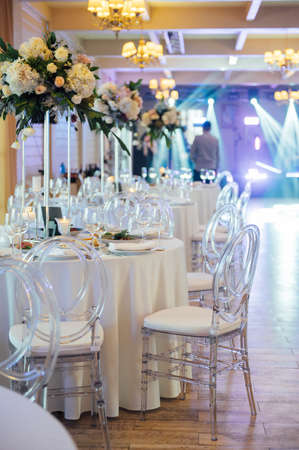 A beautiful vase of flowers on a table in a luxury restaurant. Wedding decorationsの写真素材
