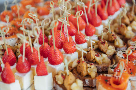 Sandwiches, canapes and cakes on the festive table. A wide variety of snacksの写真素材