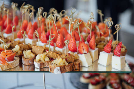 Sandwiches, canapes and cakes on the festive table. A wide variety of snacksの写真素材