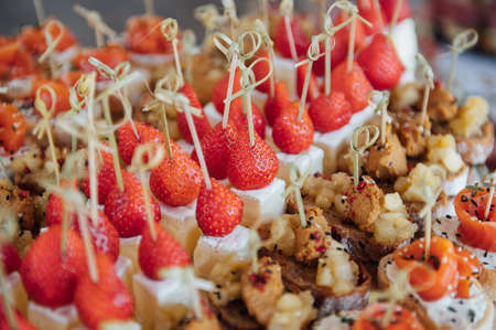 Sandwiches, canapes and cakes on the festive table. A wide variety of snacksの写真素材