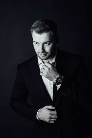 Handsome male businessman with suit posing in a photo studio. Half-length portraitの写真素材