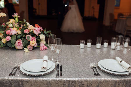 Luxurious restaurant. Luxurious interior, white tables, serving dishes and glasses for guestsの写真素材