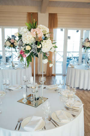 A beautiful vase of flowers on a table in a luxury restaurant. Wedding decorationsの写真素材