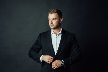 Handsome male businessman with suit posing in a photo studio. Half-length portraitの写真素材
