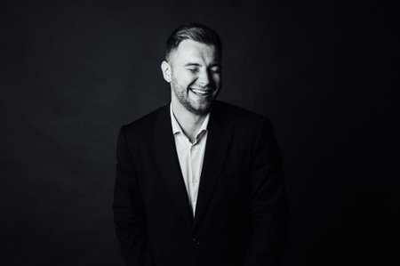 Handsome male businessman with suit posing in a photo studio. Half-length portraitの写真素材