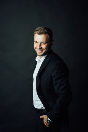 Handsome male businessman with suit posing in a photo studio. Half-length portraitの写真素材