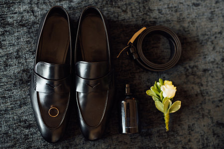 Wedding morning. The groom accessories lie on the gray bedspreadの写真素材