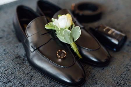 Wedding morning. The groom accessories lie on the gray bedspreadの写真素材