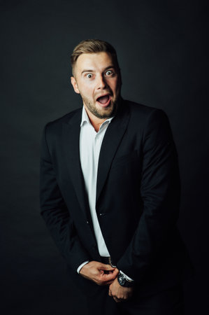 Handsome male businessman with suit posing in a photo studio. Half-length portraitの写真素材