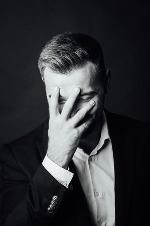 Handsome male businessman with suit posing in a photo studio. Half-length portraitの写真素材