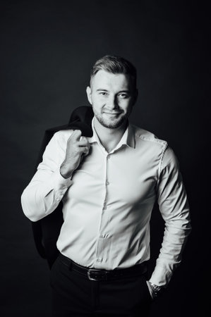Handsome male businessman with suit posing in a photo studio. Half-length portraitの写真素材
