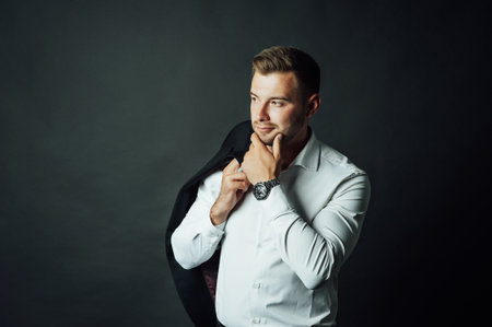Handsome male businessman with suit posing in a photo studio. Half-length portraitの写真素材