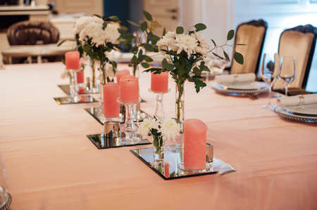 Luxurious restaurant. Luxurious interior, white tables, serving dishes and glasses for guestsの写真素材