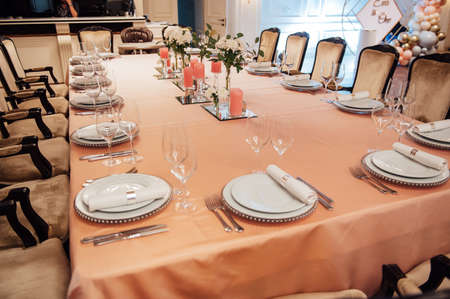 Luxurious restaurant. Luxurious interior, white tables, serving dishes and glasses for guestsの写真素材