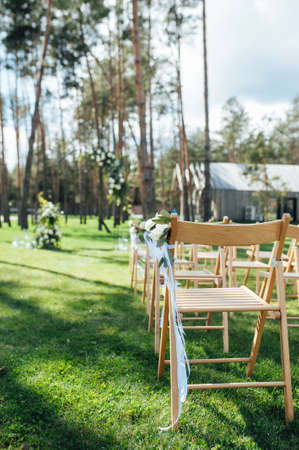 Very beautiful outside ceremony. classical wedding in forest. Metal arch with flowers.の写真素材