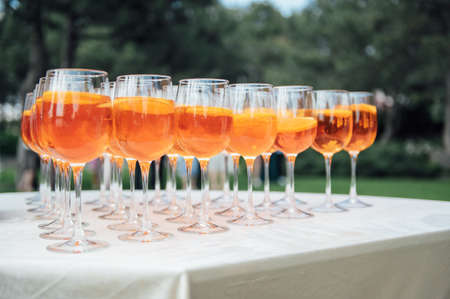 A lot of glasses with apple and orange juice on the buffet tableの写真素材
