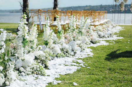 Premium arch for wedding ceremony for newlyweds on the river bank with wisteria treesの写真素材