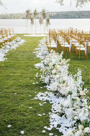 Premium arch for wedding ceremony for newlyweds on the river bank with wisteria treesの写真素材