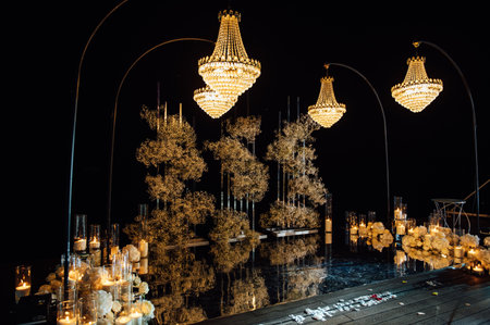 candle light in glass lanterns and gorgeous lamp at luxury wedding ceremony in evening, decor and arrangementsの写真素材