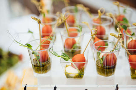 Sandwiches, canapes and cakes on the festive table. A wide variety of snacksの写真素材